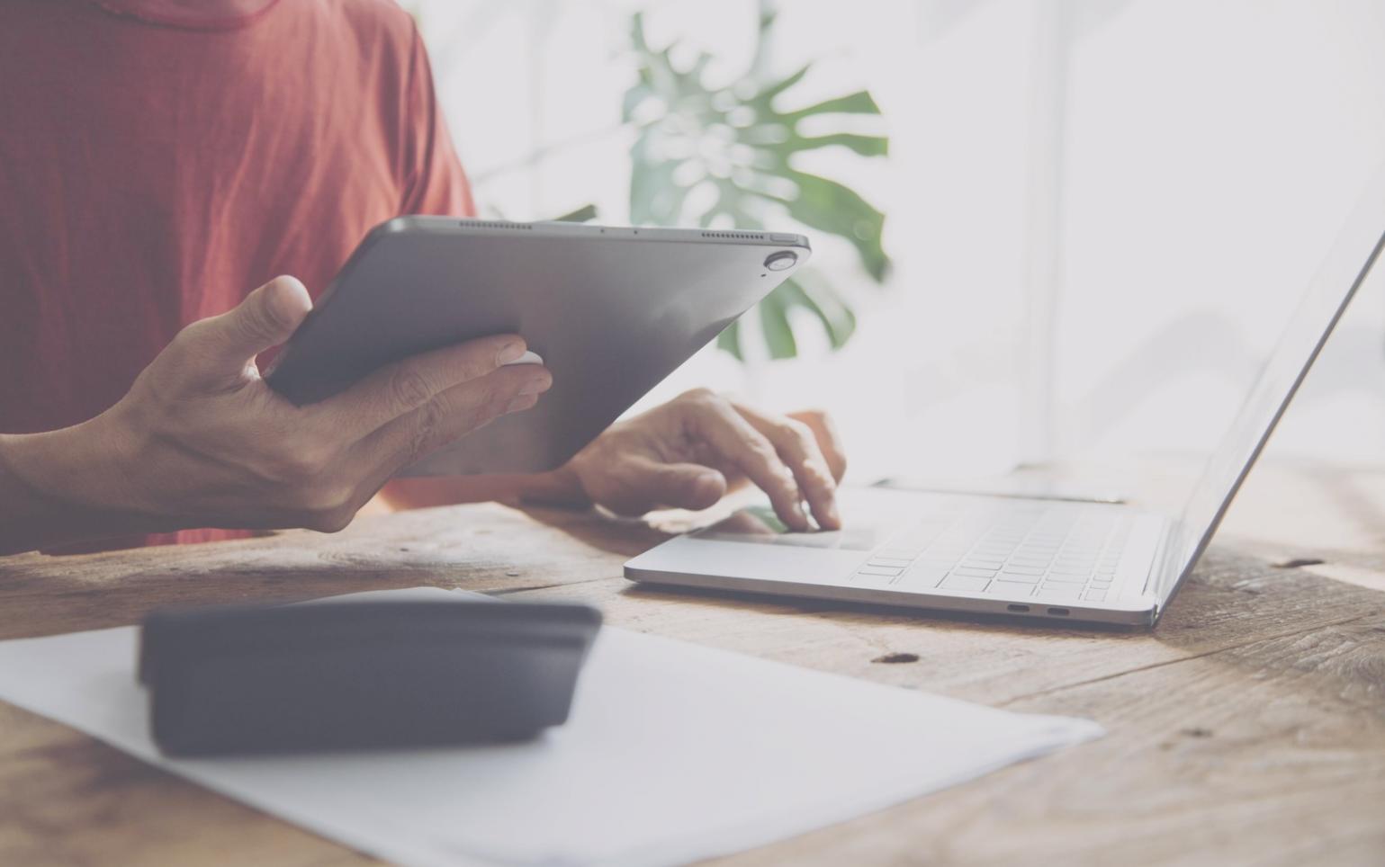 Financial planning documents and calculator showing budget analysis process